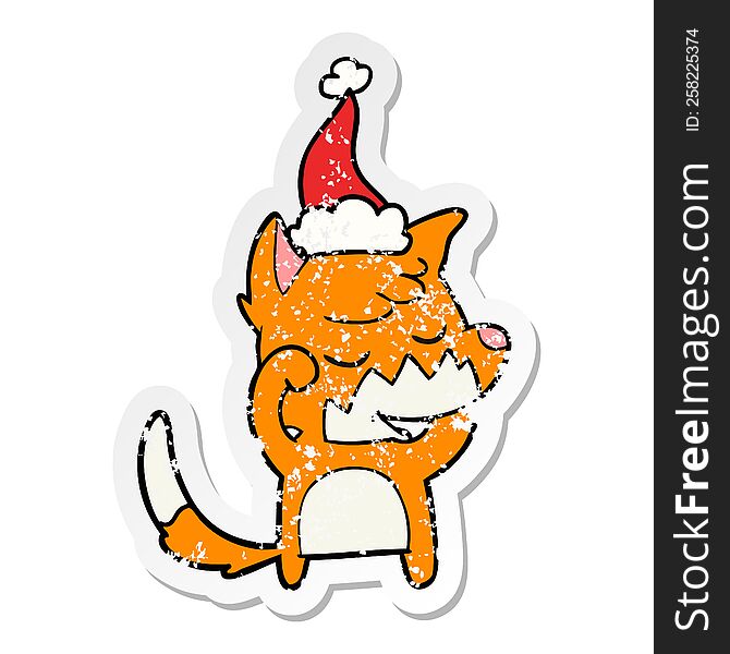 friendly distressed sticker cartoon of a fox waking up wearing santa hat