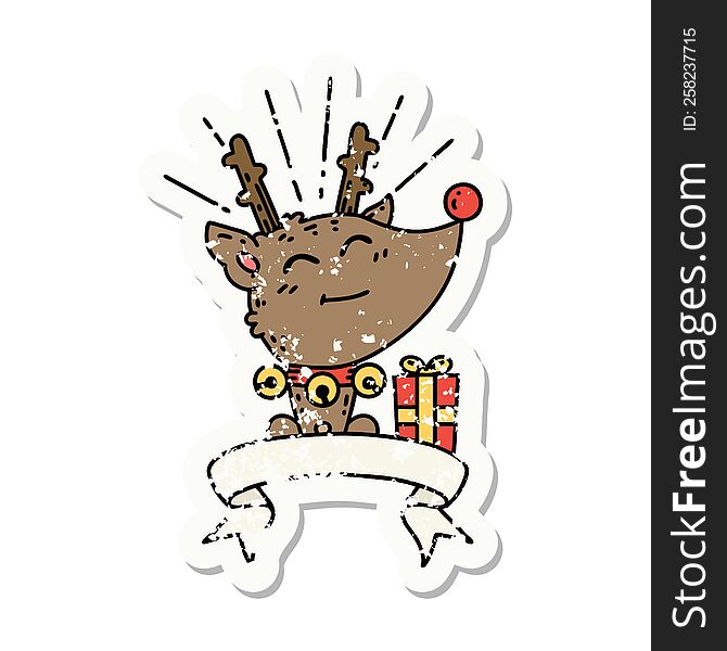worn old sticker of a tattoo style christmas reindeer with present. worn old sticker of a tattoo style christmas reindeer with present