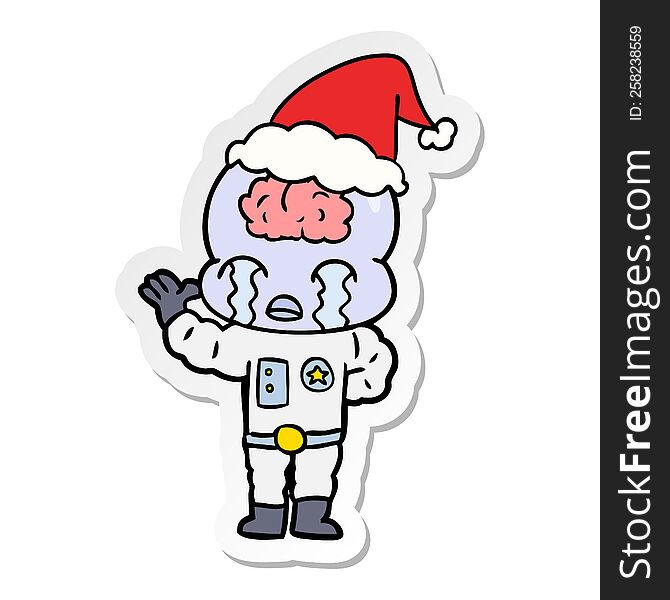 sticker cartoon of a big brain alien crying wearing santa hat