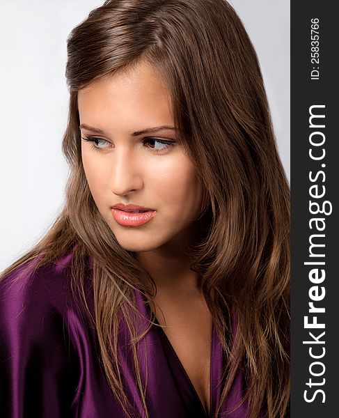 An image of a beautiful teenage girl in a purple satin top. An image of a beautiful teenage girl in a purple satin top