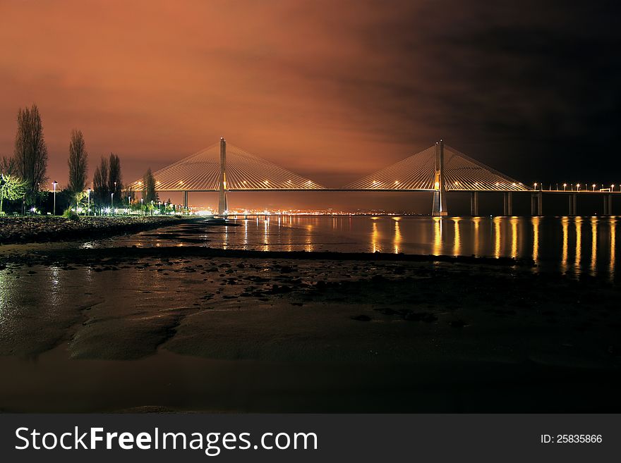 Night view of a bridge on a river in Lisbon. Night view of a bridge on a river in Lisbon