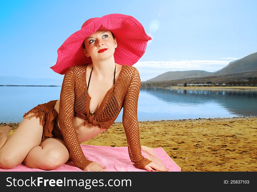 Girl On The Beach In A Red Hat