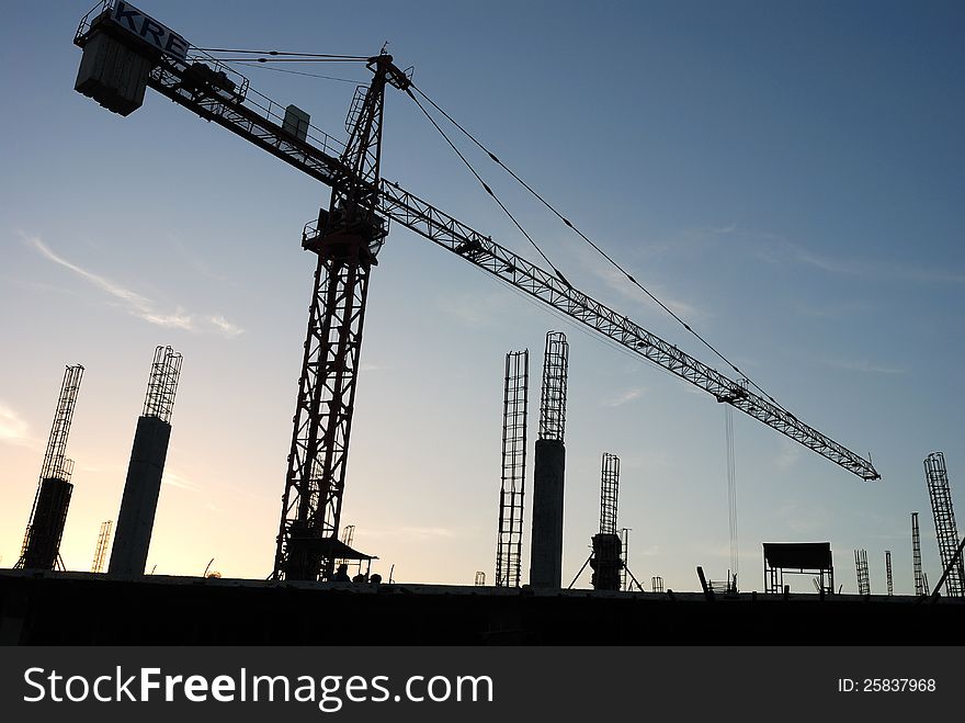 The construction crane on sunset