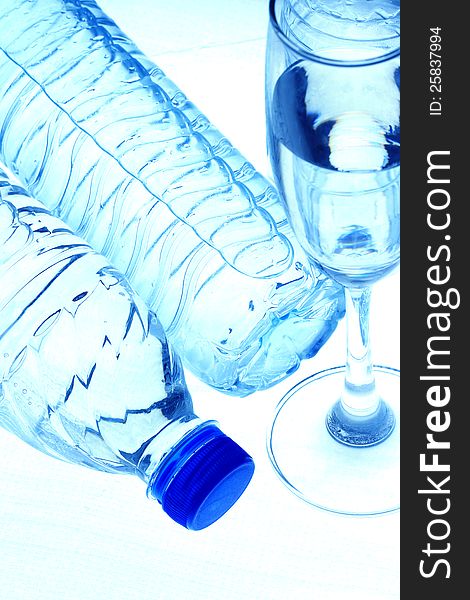 Bottles contain pure water  and glass on white background