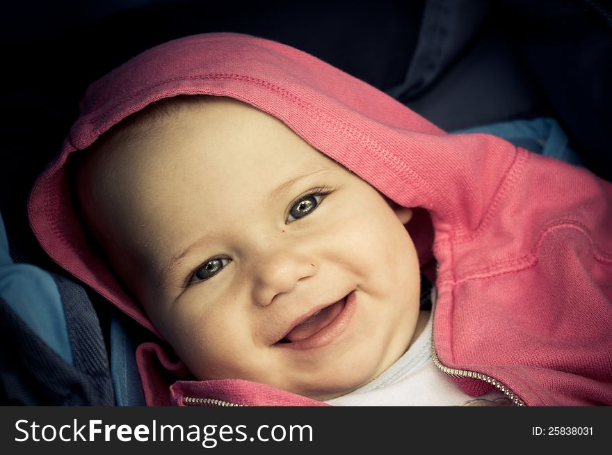 Baby with pink hood