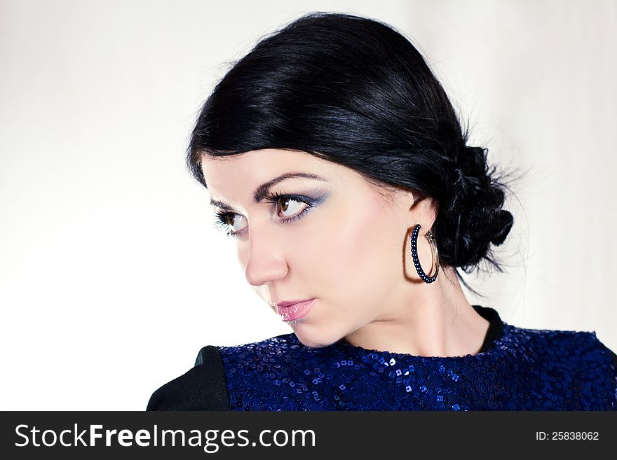 Portrait of beautiful young brunette woman in blue dress and bracelet. Portrait of beautiful young brunette woman in blue dress and bracelet