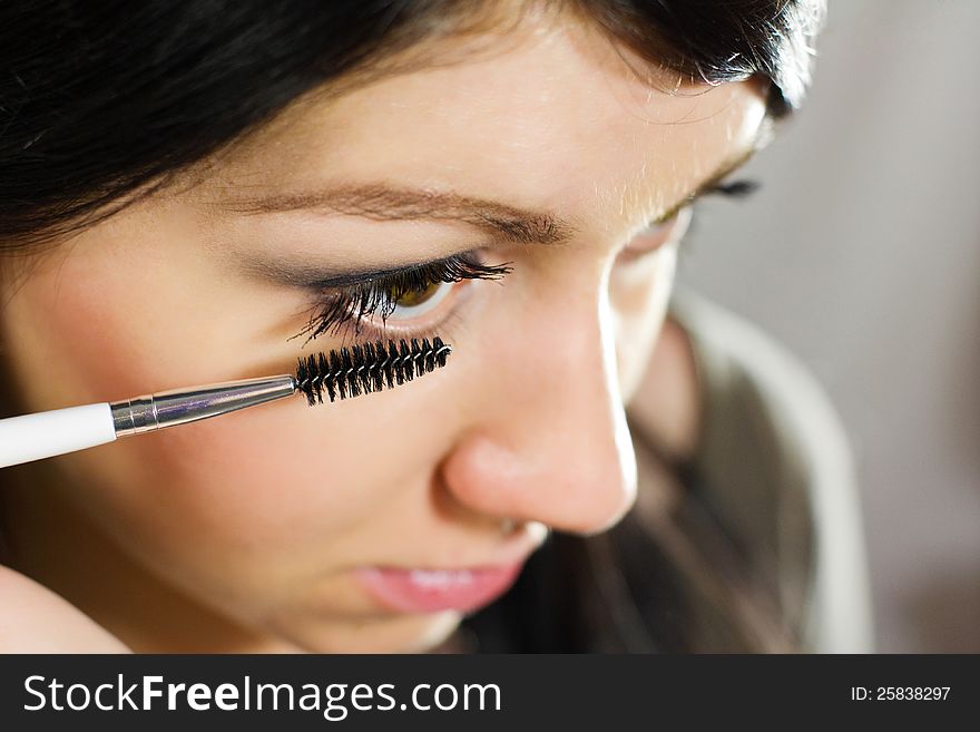 Beautiful Woman Applying Mascara On Her Eye