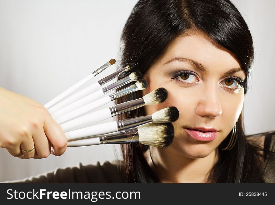 Beautiful Woman With Makeup Brushes