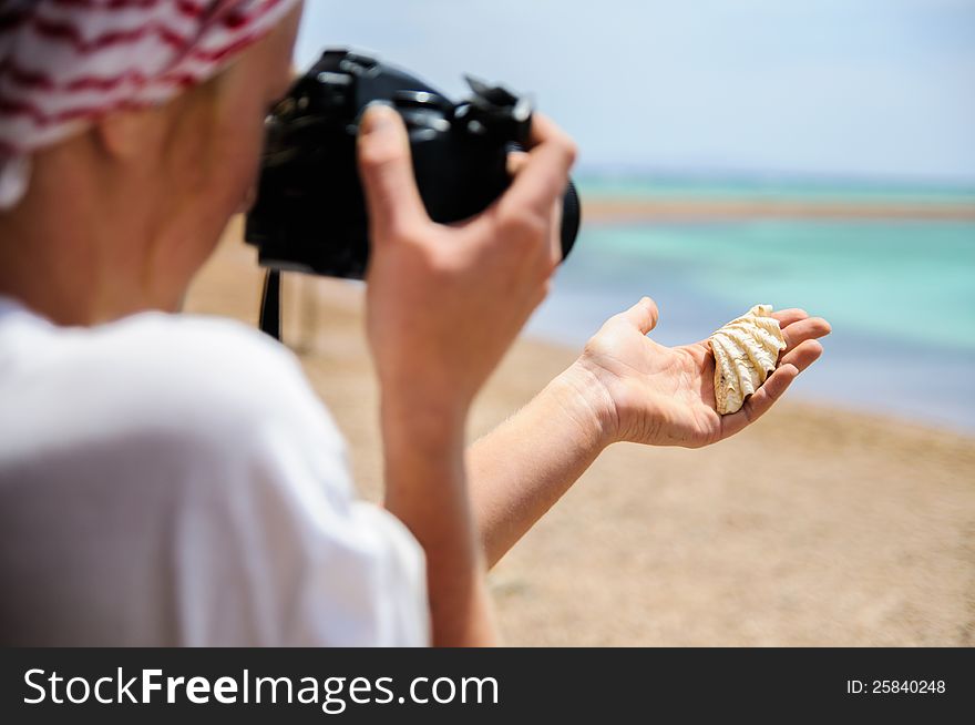 Young woman is making photo on the beach. Young woman is making photo on the beach