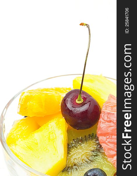 Fruits salad in a glass isolated on a white background