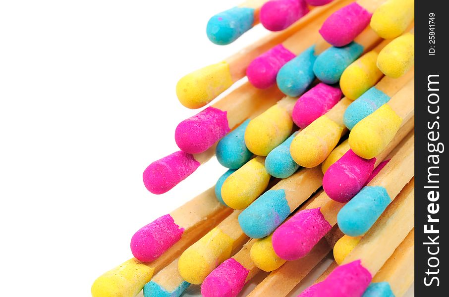 A bunch of multicolored matches on a white background with copy space. A bunch of multicolored matches on a white background with copy space