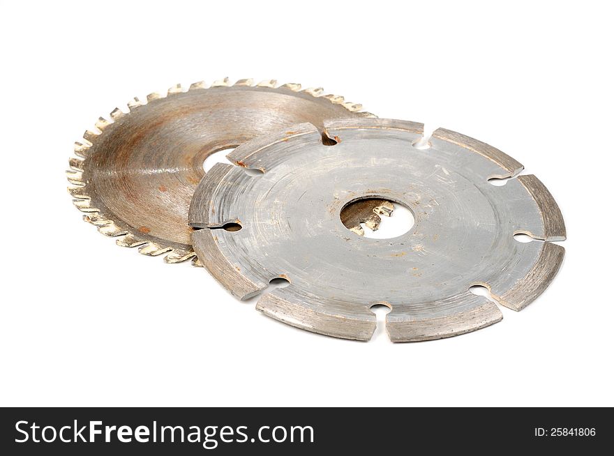 Two used circular saw blades on a white background