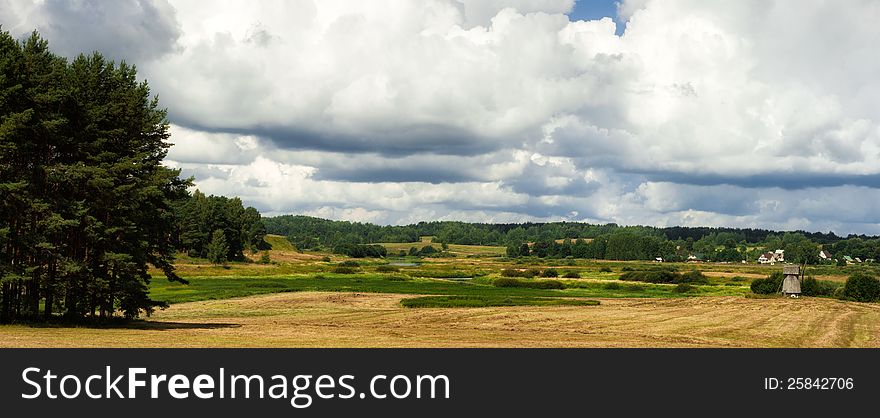 Rural landscape with old mill, thick clouds and the field. Rural landscape with old mill, thick clouds and the field