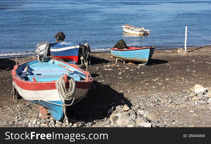 Colorful wooden fishing boats pulled ashore