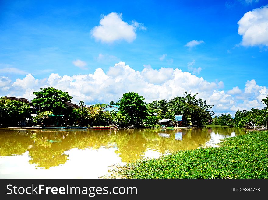 A landscape of river and community nearby the river in Thailand. A landscape of river and community nearby the river in Thailand.