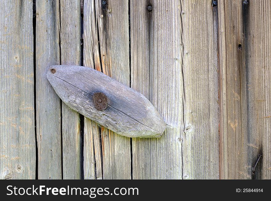 Wooden latch on the old barn door. Wooden latch on the old barn door