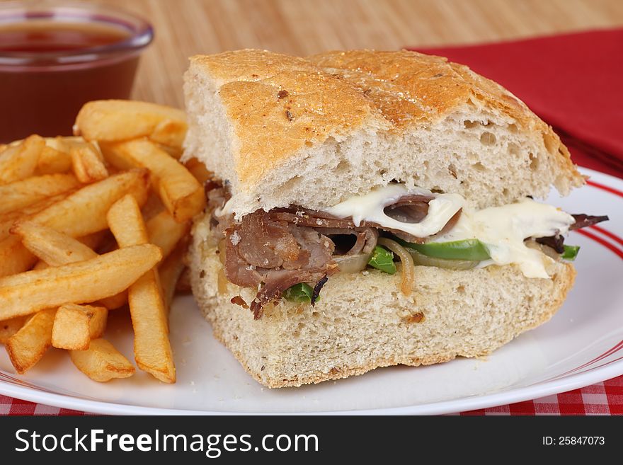 Roast beef and cheese sandwich with french fries