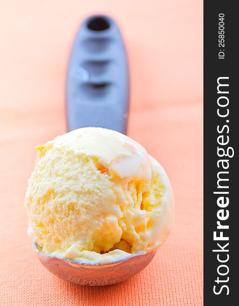 Homemade apricot ice cream with one large scoop. Homemade apricot ice cream with one large scoop
