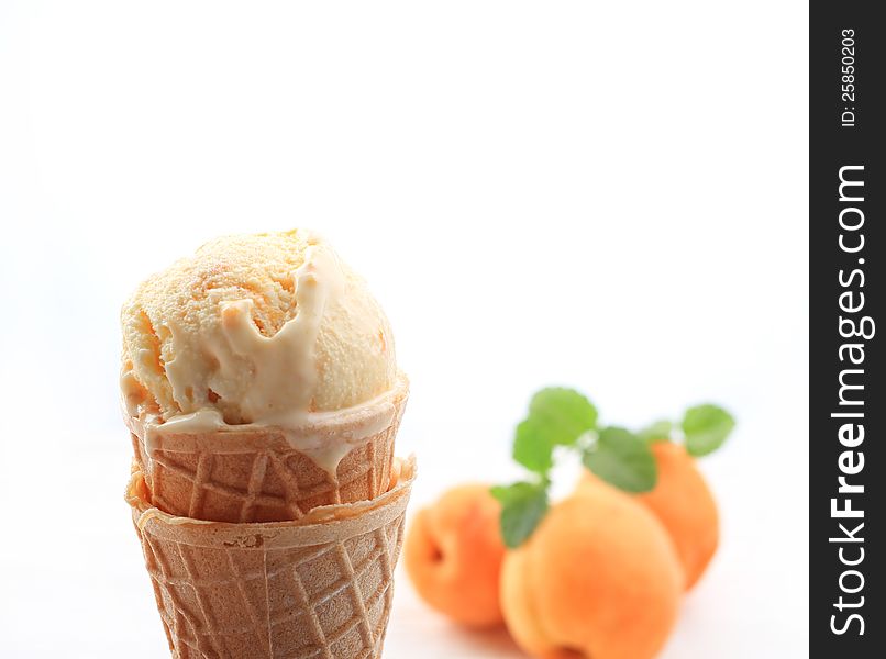 Apricot ice cream with cone on white background