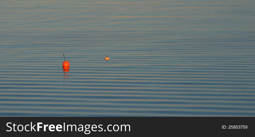 Two buoys on water ripples