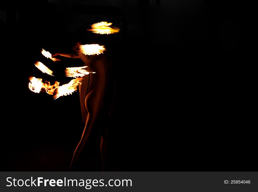 Silhouette of young woman with flames