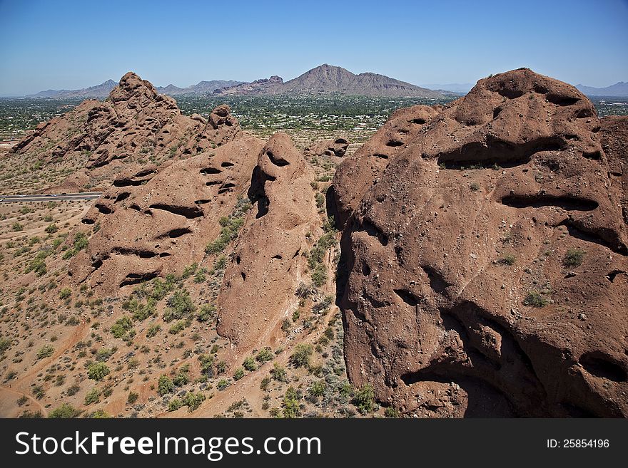 Aerial view of the red rocks in Papago Park with Camelback Mountain in the distance