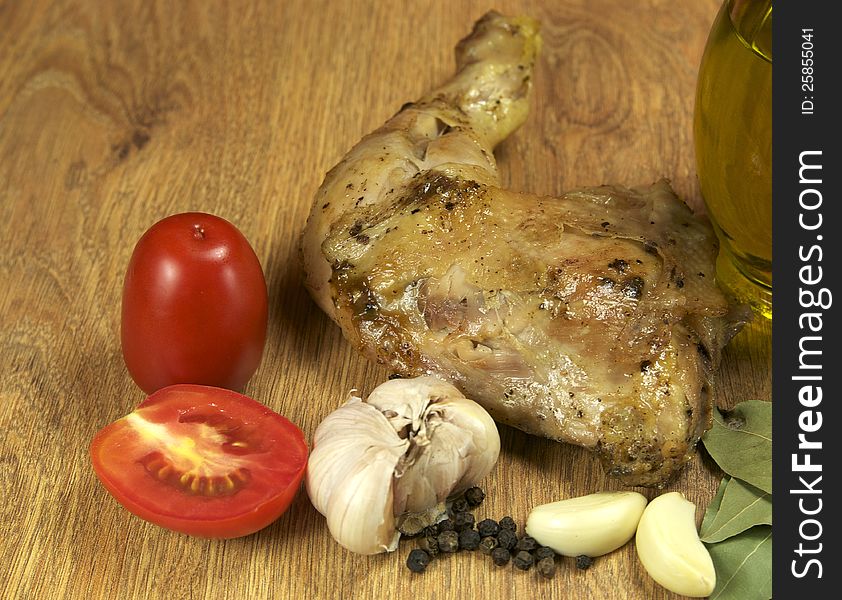 Chicken leg with pepper and butter on a wooden table. Chicken leg with pepper and butter on a wooden table