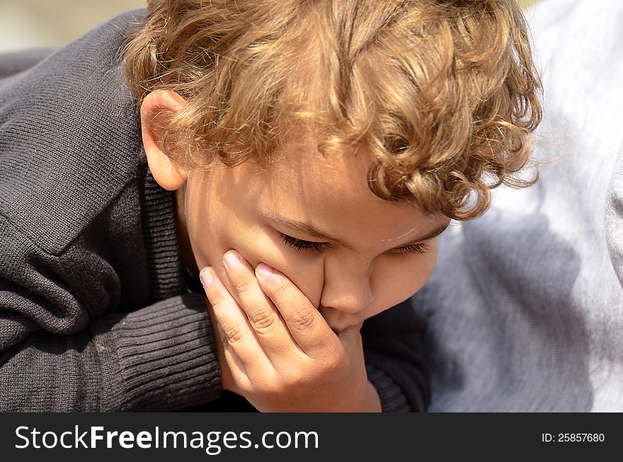 Boy making a funny face with hand