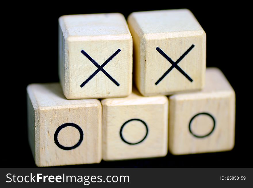 Wooden boxes with sign x and o on them.