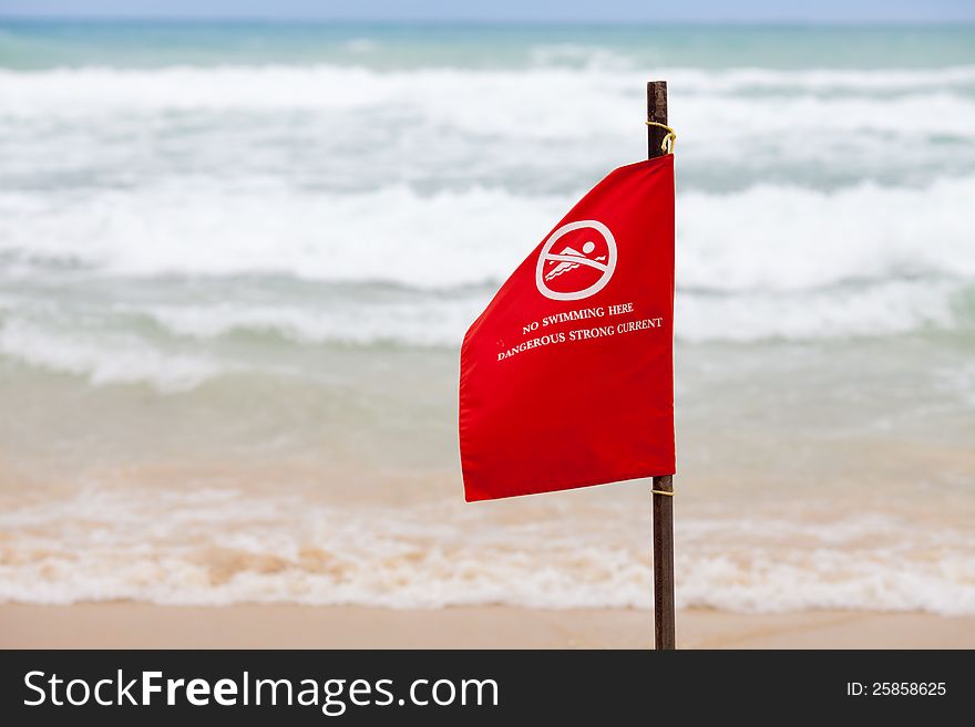 No swimming here dangerous strong current warning flag on beach. No swimming here dangerous strong current warning flag on beach