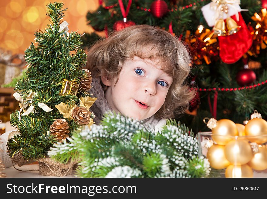 Happy child having fun against Christmas tree with decorations