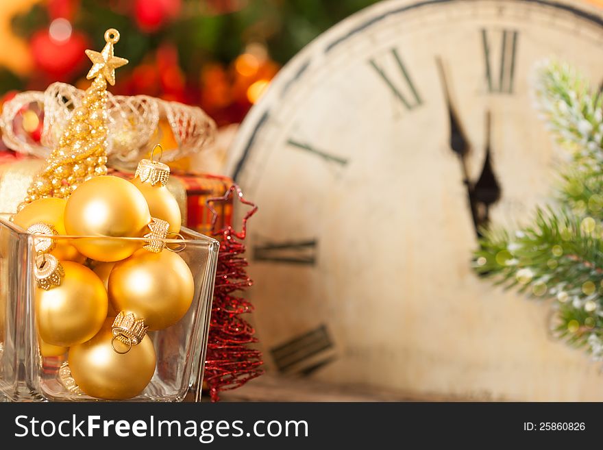 Christmas decorations against old clock at midnight. New year concept. Christmas decorations against old clock at midnight. New year concept
