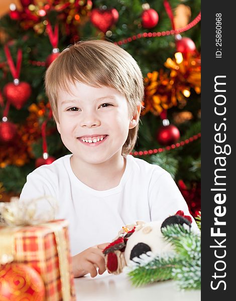 Happy smiling kid against decorated Christmas tree. Happy smiling kid against decorated Christmas tree