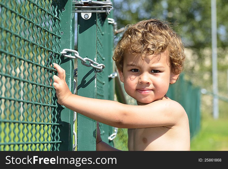 A boy who tries to sneak out through the gate. A boy who tries to sneak out through the gate.