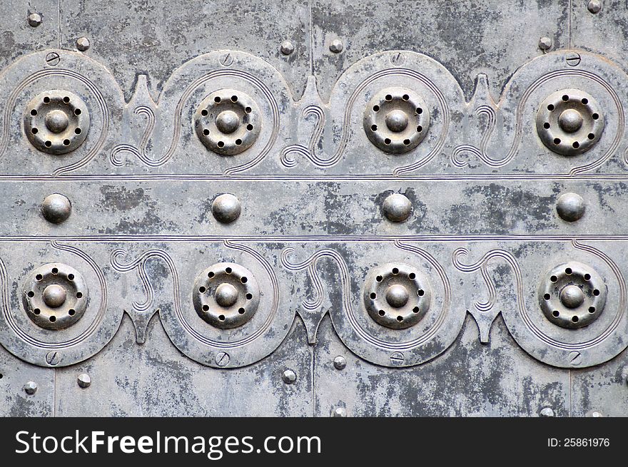 Ornaments on The iron door of an old gothic church. Ornaments on The iron door of an old gothic church.