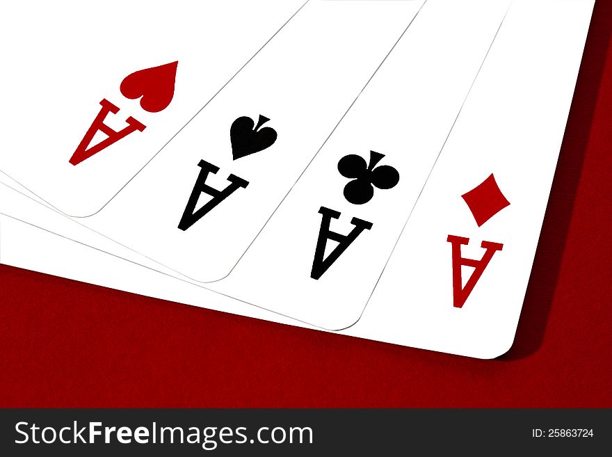 Four aces on red cloth