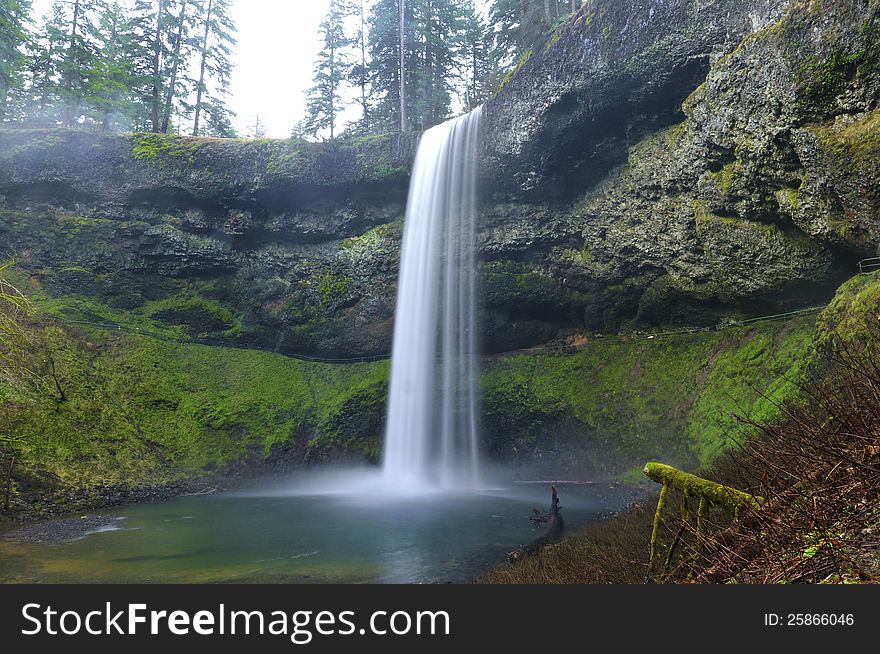 Natural beautiful waterfall in landscape. Panoramic view of the landscape with mossy rocks and pristine water. Natural beautiful waterfall in landscape. Panoramic view of the landscape with mossy rocks and pristine water.