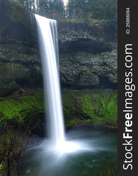 Natural beautiful waterfall in landscape. Panoramic view of the landscape with mossy rocks and pristine water. Natural beautiful waterfall in landscape. Panoramic view of the landscape with mossy rocks and pristine water.