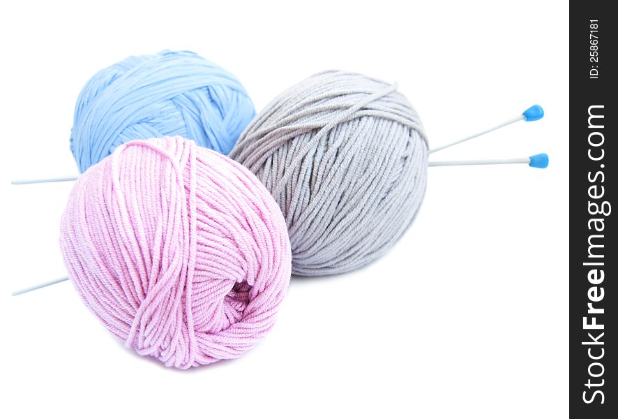 Yarn balls with needles on a white background