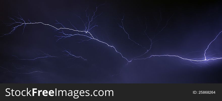 A lightning thunderbolt spreading across the sky during a summer storm. A lightning thunderbolt spreading across the sky during a summer storm