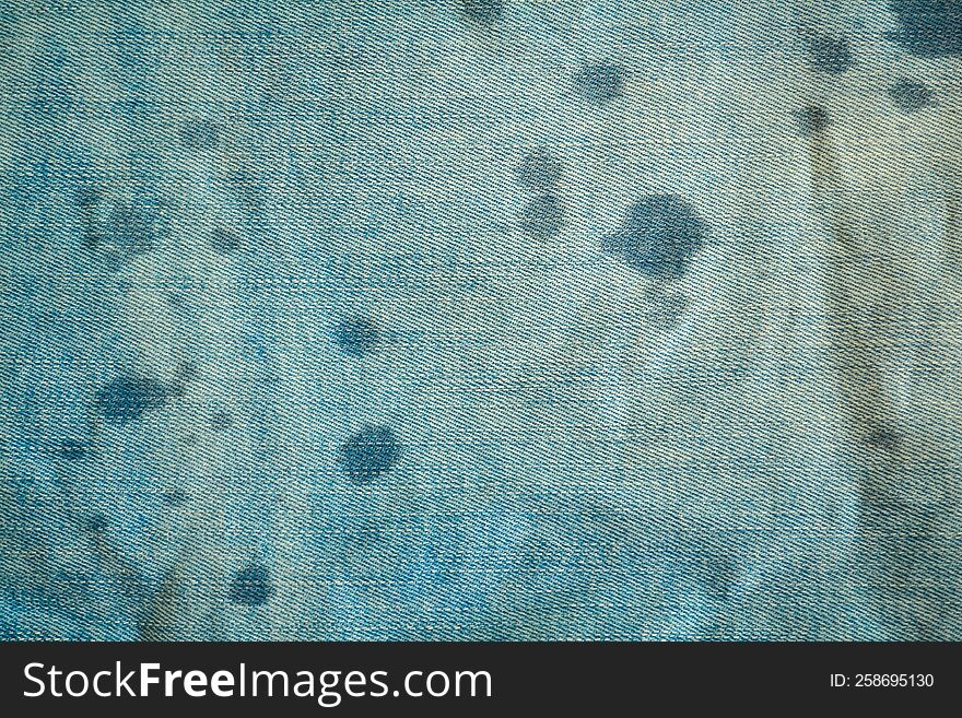 Background, texture, light blue denim and water drops.