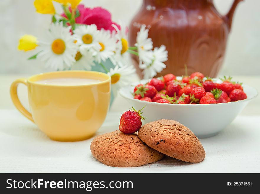 Still life with strawberries and cup of milk