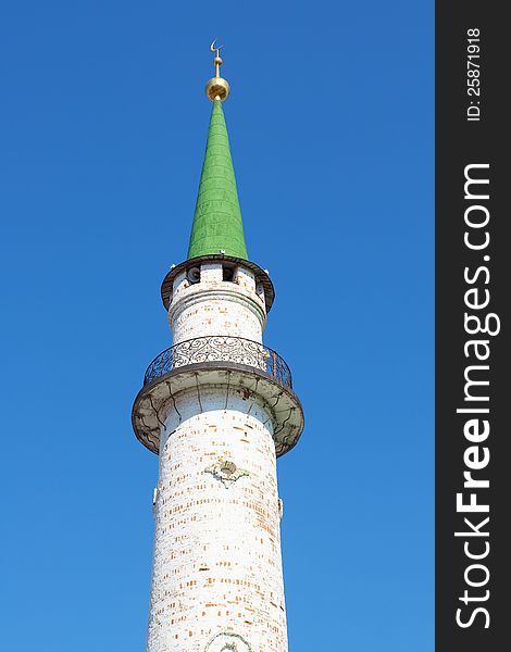 Minaret Muslim mosque towering against the blue sky