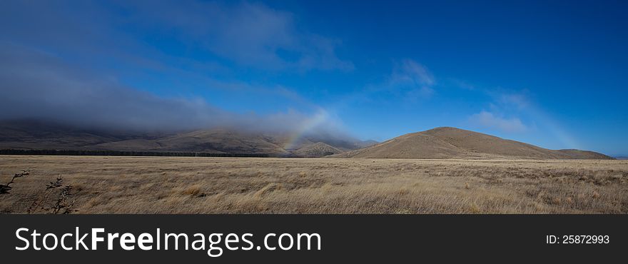 Beautiful panoramic rainbow along Burk's Pass region south island New Zealand. Beautiful panoramic rainbow along Burk's Pass region south island New Zealand