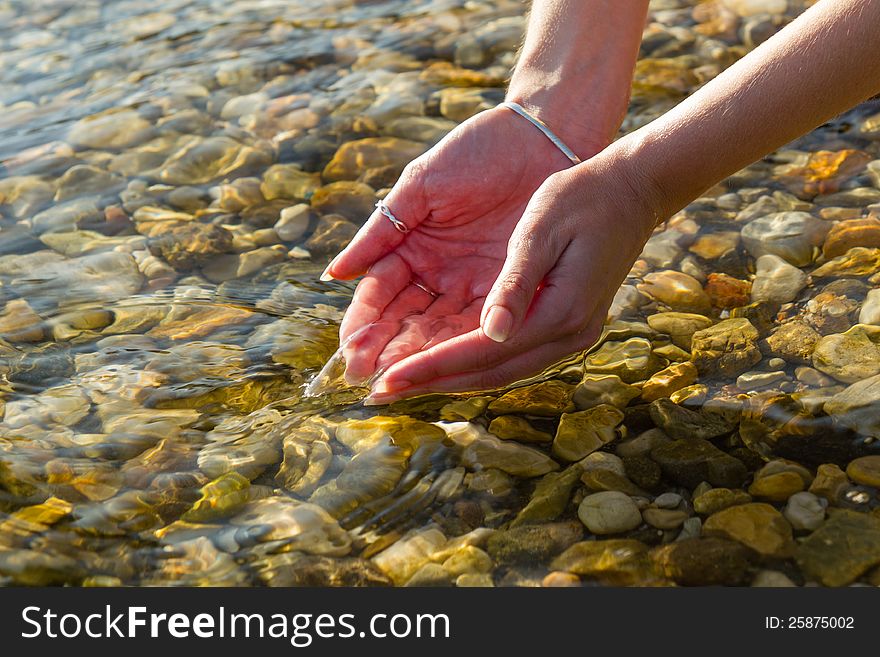 Hands Picking Up Water