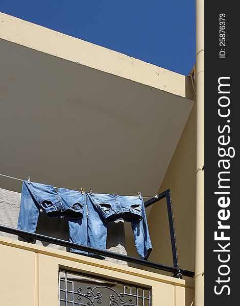 Two Jeans Drying On Balcony