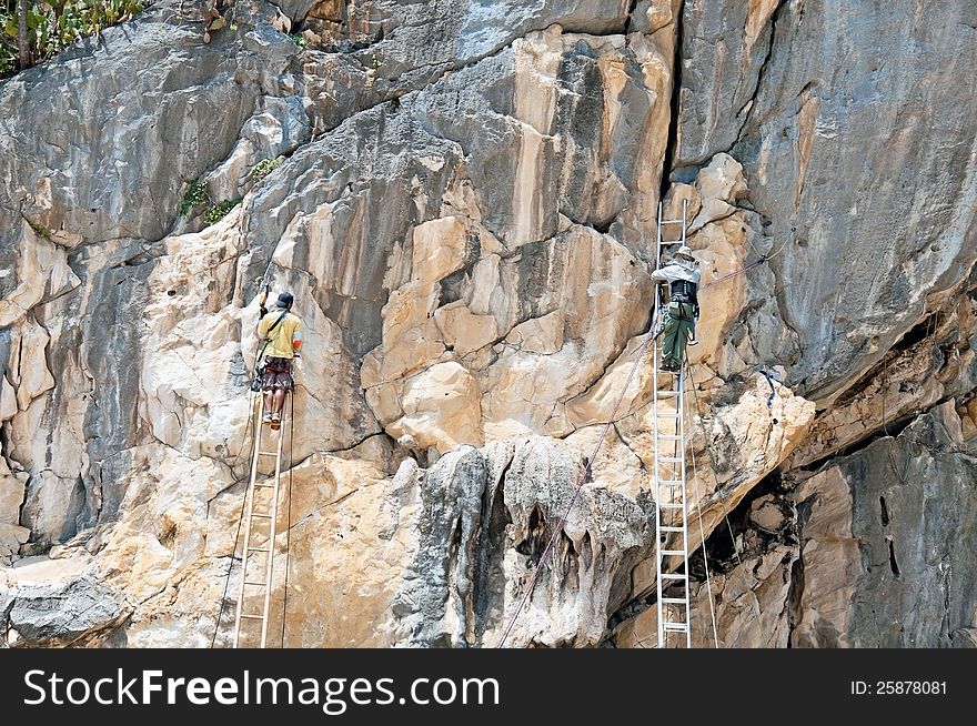 Workers made hole on the cliff for lamp installation.pranburi,thailand. Workers made hole on the cliff for lamp installation.pranburi,thailand