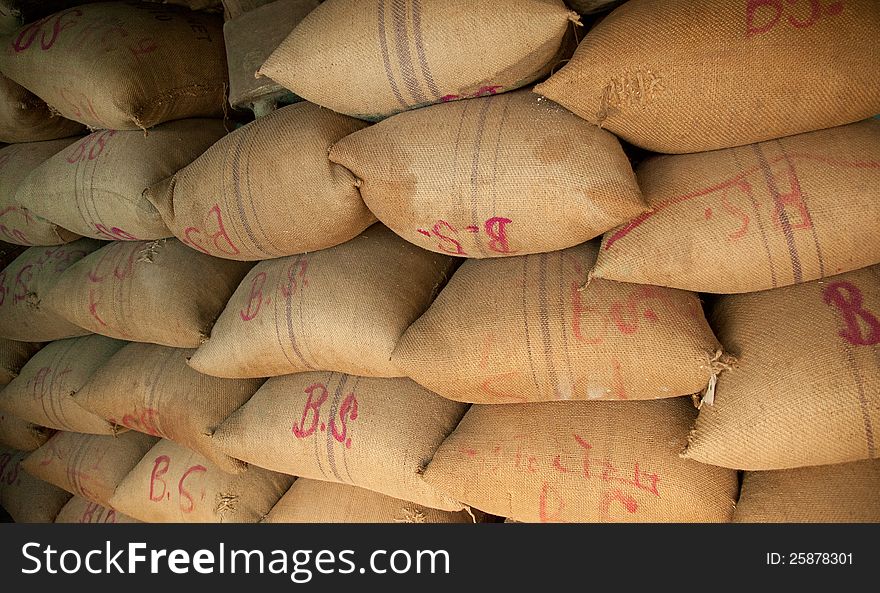 Pile of sacks having wheat stored in warehouse. Pile of sacks having wheat stored in warehouse