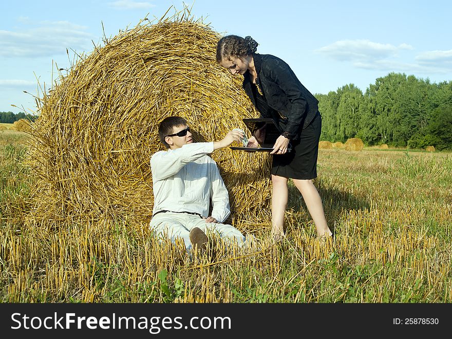 Colleagues are working with a laptop on the nature