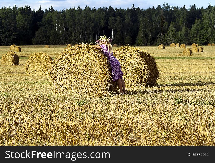 Beautiful girl near a sheaf of hay. Beautiful girl near a sheaf of hay